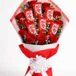 A gift set featuring 6 red roses and 5 KitKat bars wrapped for chocolate rose bouquet delivery.