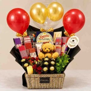 A festive gift basket with a teddy bear and chocolates, available for gift basket delivery Lahore.