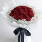 Red Rose Delivery Lahore bouquet with white wrapping and black ribbon