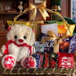 "Luxury birthday gift hamper containing a plush teddy bear, assorted premium chocolates, and snacks in a decorative basket."