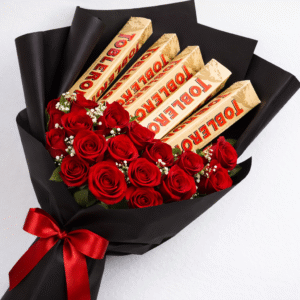 A bouquet of red roses and Toblerone bars wrapped in black paper for chocolate rose bouquet delivery.