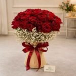 A luxurious bouquet of red roses and baby's breath from a professional flower shop in Lahore.