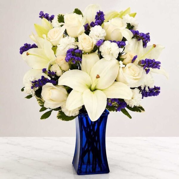 An elegant lily and rose arrangement available for Flower delivery Lahore.