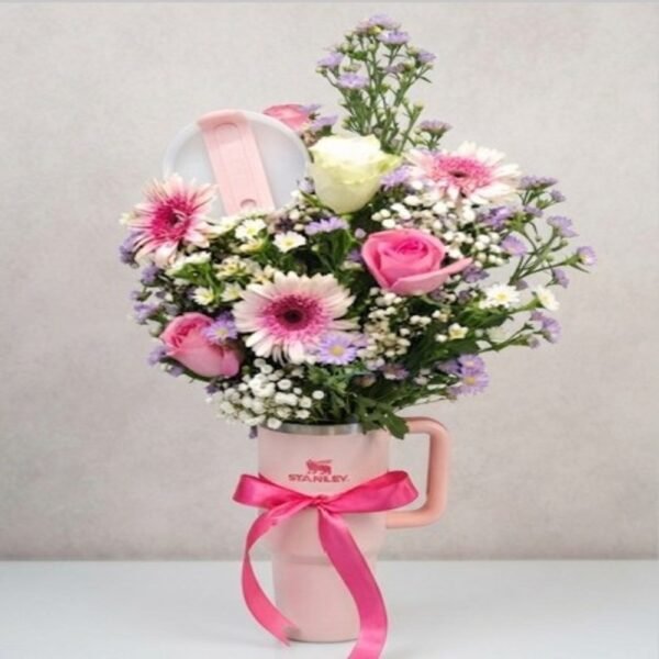 Elegant floral arrangement in a Stanley mug, available via online flower delivery Lahore.