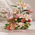 Elegant lilies and chocolates in a box, available through our gift delivery services.