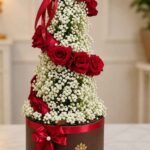 Spiral red rose floral tower centerpiece for professional flower delivery in Lahore.